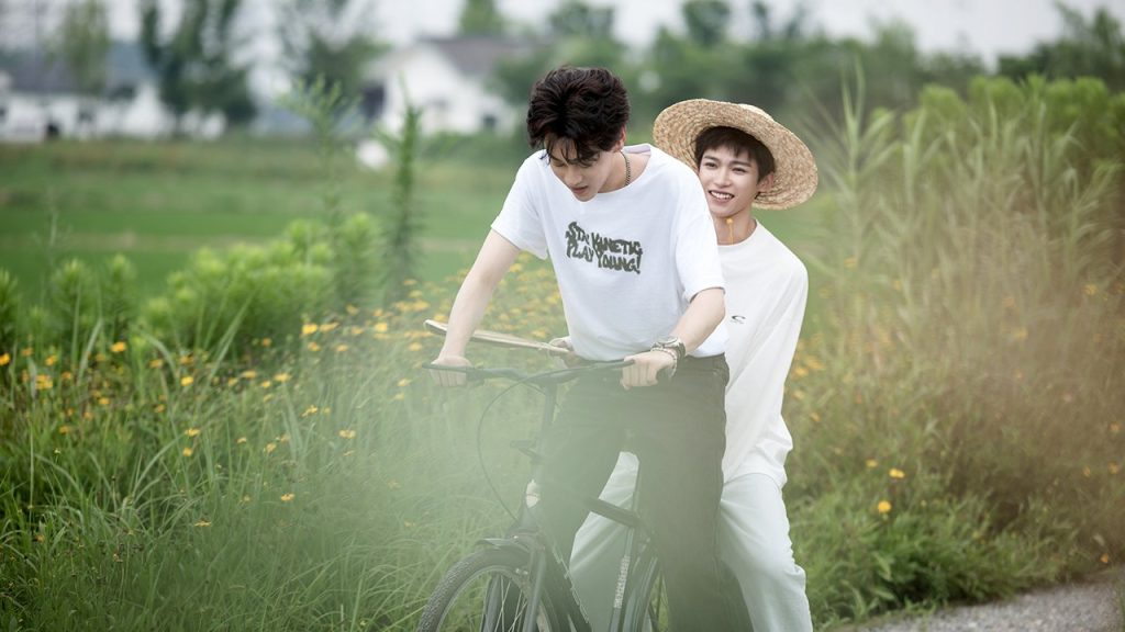 Wu Suo Wei and Chi Cheng in the countryside riding a bike